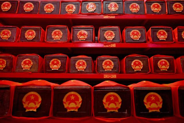 Caskets containing the remains of fallen soldiers are seen inside a holding room at Le Thi Rieng Park in Ho Chi Minh City on October 13, 2026. Vietnam held funeral rites for more than 700 of its war dead on October 14, unearthed in a major push to identify those missing from decades of conflict with France and the United States. (Photo by Nhac NGUYEN / AFP)