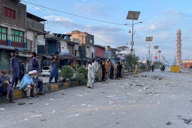 People gather on a street near the National Database and Registration Authority (NADRA) office following clashes, in Bara of Pakistan's Khyber-Pakhtunkhwa province on October 14, 2026. Police opened fire at a protest in northwest Pakistan on October 13, leaving several people injured, as authorities cracked down on supporters of jailed former prime minister Imran Khan, a police official and a member of his party said. (Photo by Abdul MAJEED / AFP)