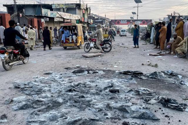 People gather on a street near the National Database and Registration Authority (NADRA) office following clashes, in Bara of Pakistan's Khyber-Pakhtunkhwa province on October 14, 2026. Police opened fire at a protest in northwest Pakistan on October 13, leaving several people injured, as authorities cracked down on supporters of jailed former prime minister Imran Khan, a police official and a member of his party said. (Photo by Abdul MAJEED / AFP)