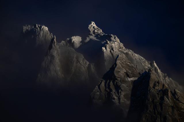 (FILES) This photograph shows the Massif of Les Grands Charmoz near L'aiguille du Midi of the Massif du Mont-Blanc mountain range in the French Alps in France France, on February 11, 2026. Mont Blanc, the highest peak in Western Europe in the Alps, was measured in September 2026 at 4,807.47 meters—1.88 meters higher than the previous measurement reported in 2023—French surveyors announced on October 14, 2026. (Photo by OLIVIER CHASSIGNOLE / AFP)