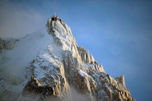 (FILES) This photograph shows L'aiguille du Midi of the Massif du Mont-Blanc mountain range in the French Alps in France France, on February 11, 2026. Mont Blanc, the highest peak in Western Europe in the Alps, was measured in September 2026 at 4,807.47 meters—1.88 meters higher than the previous measurement reported in 2023—French surveyors announced on October 14, 2026. (Photo by OLIVIER CHASSIGNOLE / AFP)
