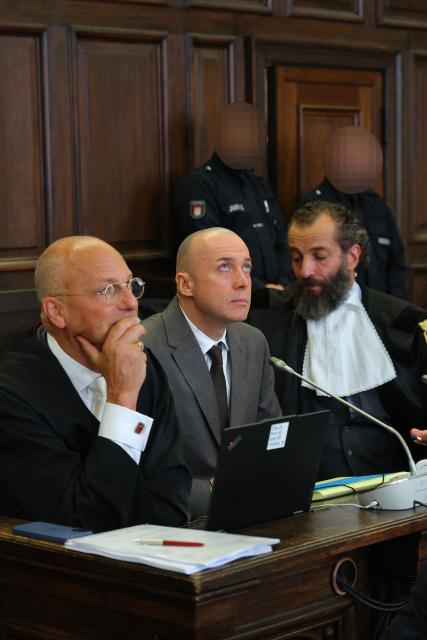 Former Ukrainian military officer Sergiy K (C, also Serhii K) is seen between his lawyers prior to the start of the trial over the Nord Stream gas pipeline bombing around four years ago, in Hamburg, northern Germany on October 14, 2026. According to the indictment filed by the Federal Public Prosecutors Office, Serhii K, who was arrested in 2025 while on vacation in Italy, is alleged to have planned the act together with other members of the Ukrainian military. In addition, the defendant is said to have led the team that blew up the natural gas pipelines under the Baltic Sea at the end of September 2022. The pipelines were used to transport Russian natural gas to Germany. According to the indictment, the attack was carried out on behalf of Ukrainian state authorities; the background was the Russian war of aggression against Ukraine, which began in early 2022. The Ukrainian government denies any official involvement. (Photo by Markus Scholz / POOL / AFP)