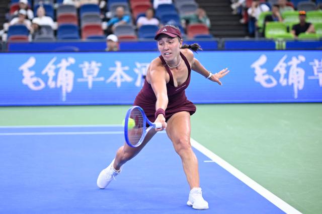 USA's Jessica Pegula hits a return to Latvia's Jelena Ostapenko during their women's singles match at the Wuhan Open tennis tournament in Wuhan, China's Hubei province on October 14, 2026. (Photo by WANG Zhao / AFP)