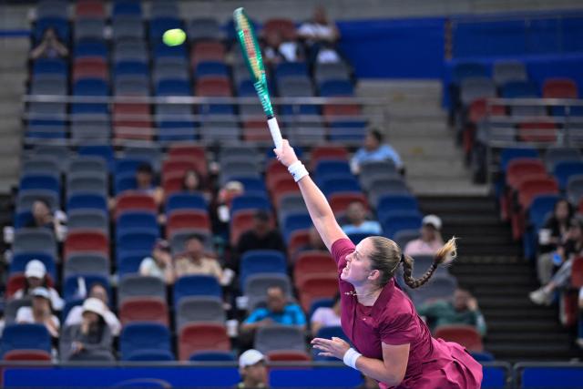 Latvia's Jelena Ostapenko serves to USA's Jessica Pegula during their women's singles match at the Wuhan Open tennis tournament in Wuhan, China's Hubei province on October 14, 2026. (Photo by WANG Zhao / AFP)