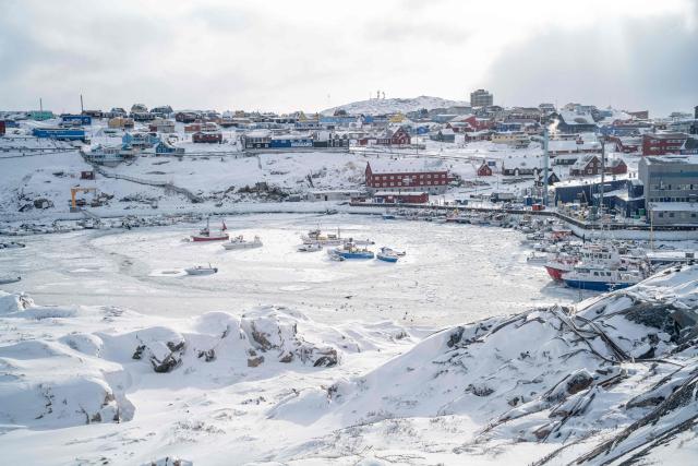 (FILES) This photograph, taken from the Hotel Arctic, shows the port of Ilulissat trapped in ice, in Greenland, on March 19, 2026. US President Donald Trump said on October 14, 2026 that oil, gas and mineral exploration was preparing to begin in Greenland, and hailed the Arctic island's position for US and European security. (Photo by Florent VERGNES / AFP)