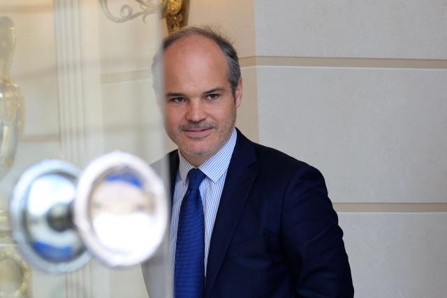 French presidency's international communication advisor Jonas Bayard leaves the presidential Elysee Palace following the weekly Cabinet meeting in Paris on October 14, 2026. (Photo by Ludovic MARIN / AFP)