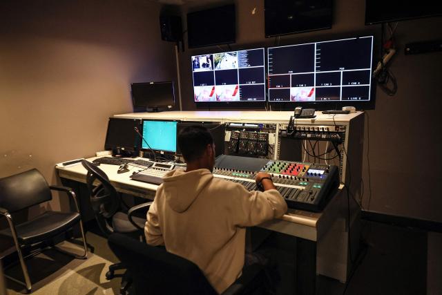 An employee works inside a control room at Turkey's most-watched news channel Halk TV in Ankara on October 14, 2026 as Police raided Halk TV halting broadcasts and installing a government-appointed administrator in the latest move against pro-opposition media. It was the latest move against media viewed as critical of Turkish President and his government, coming two weeks after officials closed the website and social media accounts of leading digital news website T24, citing "LGBT propaganda". (Photo by Adem ALTAN / AFP)