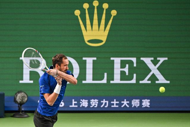 Russia's Daniil Medvedev hits a return to Greece's Stefanos Tsitsipas during their men's singles match at the Shanghai Masters tennis tournament in Shanghai on October 14, 2026. (Photo by Hector RETAMAL / AFP)