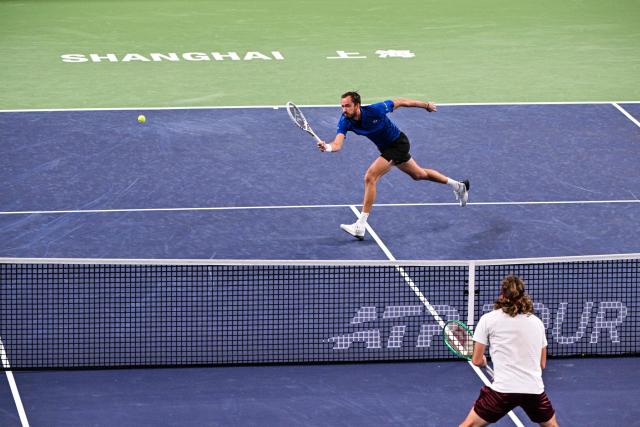 Russia's Daniil Medvedev hits a return to Greece's Stefanos Tsitsipas during their men's singles match at the Shanghai Masters tennis tournament in Shanghai on October 14, 2026. (Photo by Hector RETAMAL / AFP)