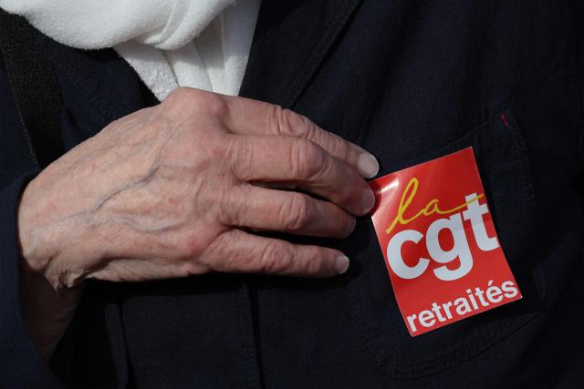 A protester wears a "CGT retirees" sticker as people gather at Place de la Bastille ahead of a march to the headquarters of supplementary pension scheme Agirc-Arrco, called by the CGT trade union to demand pensions be indexed to inflation after the 2026 freeze, in Paris, on October 14, 2026. (Photo by MEHDI FEDOUACH / AFP)