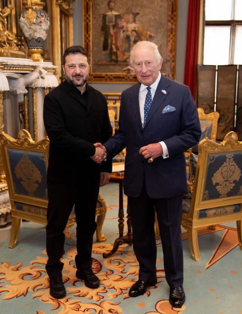 Britain's King Charles III greets President of Ukraine Volodymyr Zelensky during an audience at Buckingham Palace in central London on October 14, 2026. (Photo by Aaron Chown / POOL / AFP)