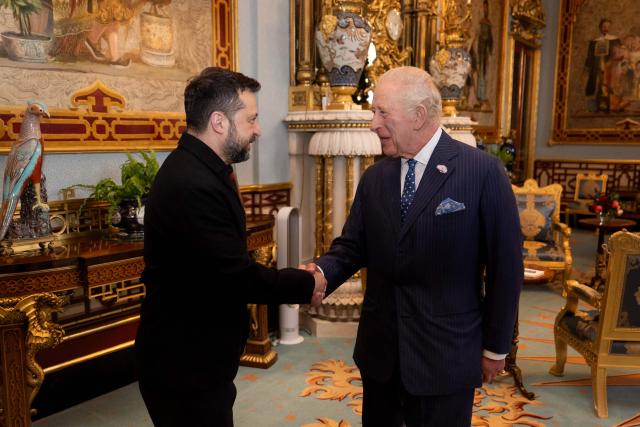 Britain's King Charles III greets President of Ukraine Volodymyr Zelensky during an audience at Buckingham Palace in central London on October 14, 2026. (Photo by Aaron Chown / POOL / AFP)