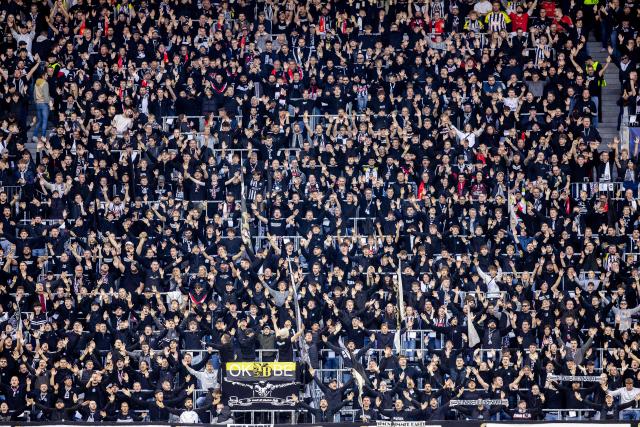 Fans of LASK cheer on their team the UEFA Champions League football match between LASK and Liverpool FC in Linz, Austria on October 14, 2026. (Photo by Branislav Racko / AFP)
