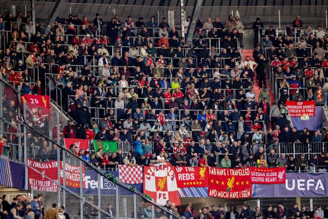 Fans of Liverpool cheer on their team the UEFA Champions League football match between LASK and Liverpool FC in Linz, Austria on October 14, 2026. (Photo by Branislav Racko / AFP)