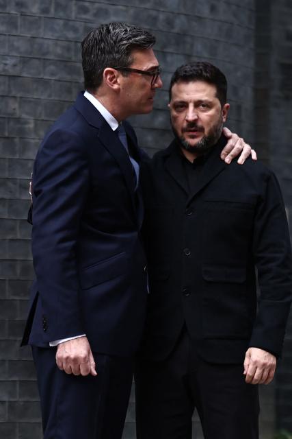 Britain's Prime Minister Andy Burnham (L) and Ukraine's President Volodymyr Zelensky (R) stand together as they meet in Downing Street in central London, on October 14, 2026, ahead of their meeting. (Photo by Henry Nicholls / POOL / AFP)