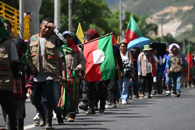 Indigenous people march during a protest against the government of Colombian President Abelardo de la Espriella during the Summit of the Indigenous Peoples of Southwest Colombia in Caldono, Cauca Department, Colombia, on October 14, 2026, as part of a nationwide day of demonstrations called by labor unions, teachers' organizations, student groups and opposition sectors. (Photo by JOAQUIN SARMIENTO / AFP)