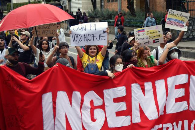 Demonstrators march during a protest against the government of Colombian President Abelardo de la Espriella in Bogota on October 14, 2026, during a nationwide day of demonstrations called by labor unions, teachers' organizations, student groups and opposition sectors. (Photo by Andrea ARIZA / AFP)