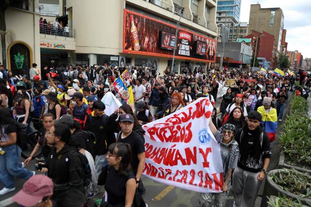 Demonstrators march during a protest against the government of Colombian President Abelardo de la Espriella in Bogota on October 14, 2026, during a nationwide day of demonstrations called by labor unions, teachers' organizations, student groups and opposition sectors. (Photo by Andrea ARIZA / AFP)