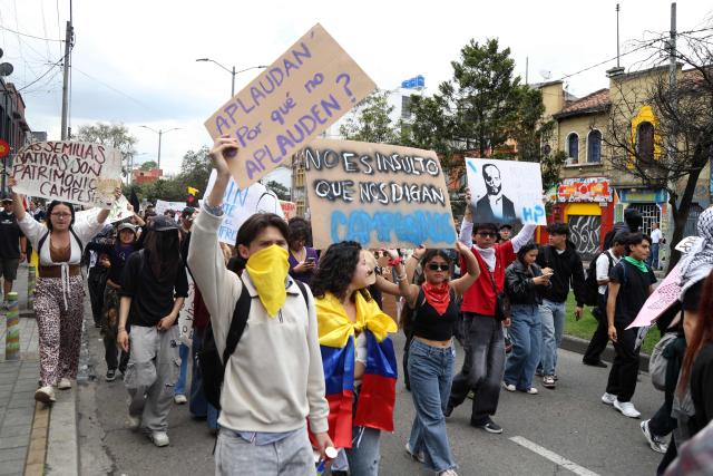 Demonstrators march during a protest against the government of Colombian President Abelardo de la Espriella in Bogota on October 14, 2026, during a nationwide day of demonstrations called by labor unions, teachers' organizations, student groups and opposition sectors. (Photo by Andrea ARIZA / AFP)