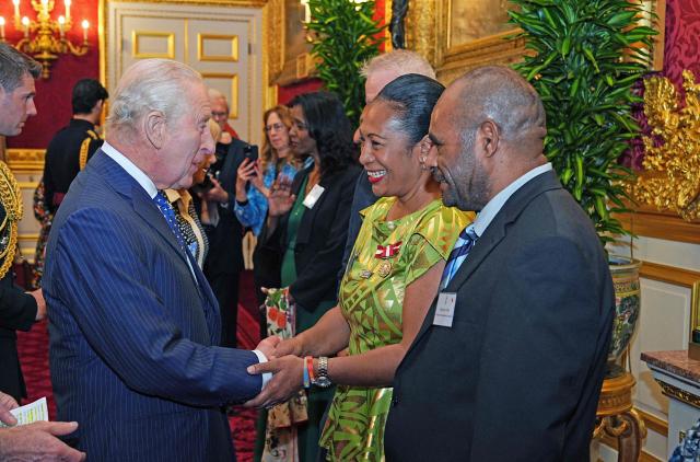 Britain's King Charles III speaks with Ana Tuiketei, the first Listed Pacific Counsel with the International Criminal Court (The Hague), during a reception for the Commonwealth Diaspora in the UK, at St James's Palace in London on October 14, 2026, ahead of the Commonwealth Heads of Government Meeting (CHOGM). (Photo by Aaron Chown / POOL / AFP)