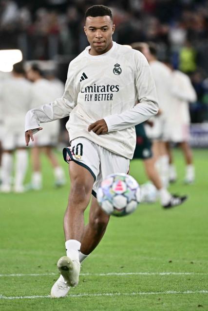 Real Madrid's French forward #10 Kylian Mbappe warms up before the UEFA Champions League - 1st round day 2 football match between AS Roma and Real Madrid at the Olympic Stadium in Rome on October 14, 2026. (Photo by Filippo MONTEFORTE / AFP)