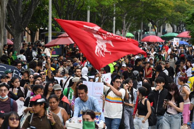 Demonstrators take part in a protest against the government of Colombian President Abelardo de la Espriella in Medellin, Colombia, on October 14, 2026, during a nationwide day of demonstrations called by labor unions, teachers' organizations, student groups and opposition sectors. (Photo by Jaime SALDARRIAGA / AFP)