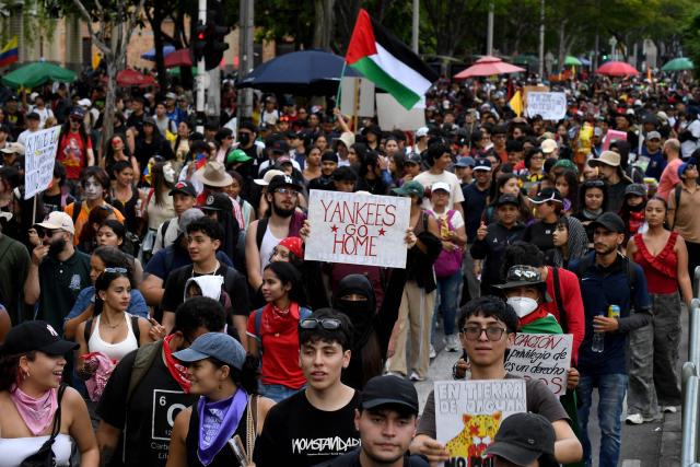 Demonstrators take part in a protest against the government of Colombian President Abelardo de la Espriella in Medellin, Colombia, on October 14, 2026, during a nationwide day of demonstrations called by labor unions, teachers' organizations, student groups and opposition sectors. (Photo by Jaime SALDARRIAGA / AFP)