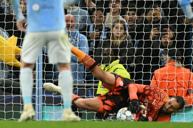 Manchester City's Italian goalkeeper #01 Gianluigi Donnarumma saves a penalty kick from Paris Saint-Germain's Spanish striker #09 Ferran Torres during the UEFA Champions League, league phase football match between Manchester City and Paris Saint Germain at the Etihad Stadium in Manchester, north west England, on October 14, 2026. (Photo by Oli SCARFF / AFP)