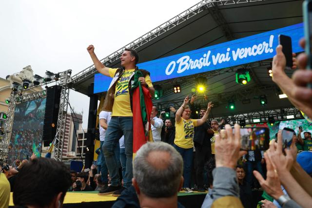 Brazil's right-wing senator and Liberal Party (PL) presidential candidate Flavio Bolsonaro greets supporters during a rally at Largo Glenio Peres in Porto Alegre, Brazil, on October 14, 2026, ahead of the presidential election runoff. Bolsonaro heads to a runoff election with leftist President Luiz Inacio Lula da Silva on October 25, buoyed by sweeping gains in Congress, after a shock first-place finish. (Photo by SILVIO AVILA / AFP)
