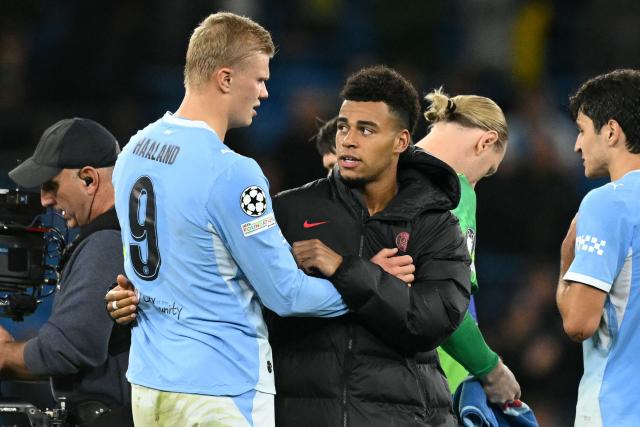 Manchester City's Norwegian striker #09 Erling Haaland (L) and Paris Saint-Germain's French midfielder #14 Desire Doue (C) chat on the pitch after the UEFA Champions League, league phase football match between Manchester City and Paris Saint Germain at the Etihad Stadium in Manchester, north west England, on October 14, 2026. PSG won the game 4-2. (Photo by Oli SCARFF / AFP)