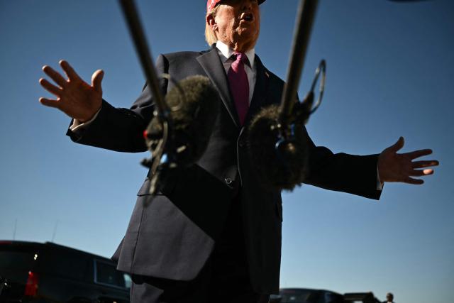 US President Donald Trump speaks to the press after addressing a campaign rally at Laughlin/Bullhead International Airport in Bullhead City, Arizona, on October 14, 2026. (Photo by Kent NISHIMURA / AFP)