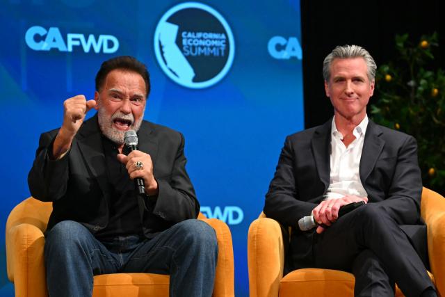 Former California governor and actor Arnold Schwarzenegger speaks whie California governor Gavin Newsom looks on during the California Economic Summit in Long Beach, California, on October 14, 2026. (Photo by Patrick T. Fallon / AFP)