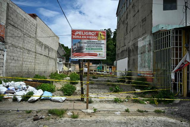 An area damaged by severe erosion and the collapse of homes following heavy rains is seen along the Pinula River in the Villa Hermosa I neighborhood of San Miguel Petapa, Guatemala, on October 14, 2026. Authorities report that the current rainy season has left 22 people dead, 44 injured and more than 212,000 affected, while causing extensive damage to infrastructure, including some 13,000 homes, 660 roads, 37 bridges and 52 schools. (Photo by Johan ORDONEZ / AFP)