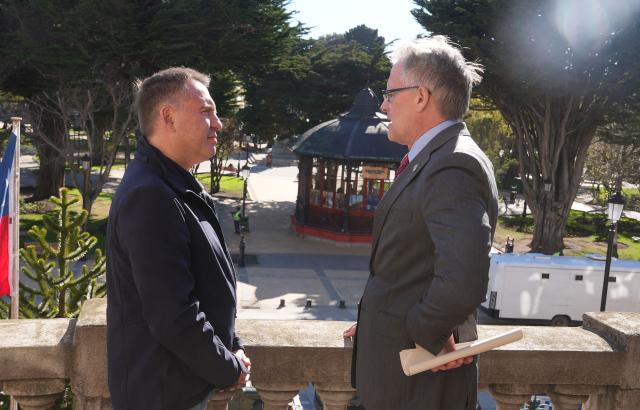 Punta Arenas Mayor Claudio Radonich (L) talks with British Ambassador to Chile David Concar during a meeting in Punta Arenas, Chile, on October 14, 2026. Business leaders from Chile and the Falkland Islands met in Punta Arenas, southern Chile, in September to finalize details of a new commercial shipping route, which is scheduled to begin operating between November and December 2026. (Photo by Claudio MONGE / AFP)