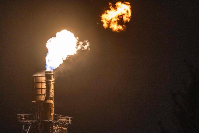 A flare stack burns off byproduct gasses at the Toa oil refinery in Kawasaki on October 14, 2026. (Photo by Andrew Caballero-Reynolds / AFP)
