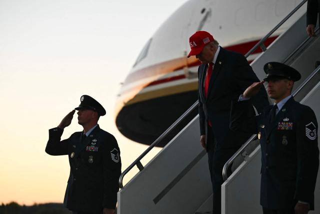 US President Donald Trump disembarks Air Force One at Glacier Park International Airport in Kalispell, Montana, on October 14, 2026. President Trump is travelling to Montana to speak at a campaign rally. (Photo by Kent NISHIMURA / AFP)