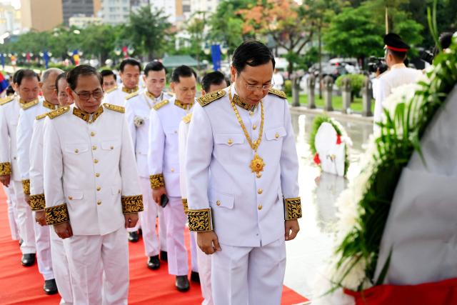 Cambodian government officials pay their respects in front of the monument of the late king Norodom Sihanouk during a ceremony commemorating his fourteenth death anniversary in Phnom Penh on October 15, 2026. (Photo by TANG CHHIN Sothy / AFP)