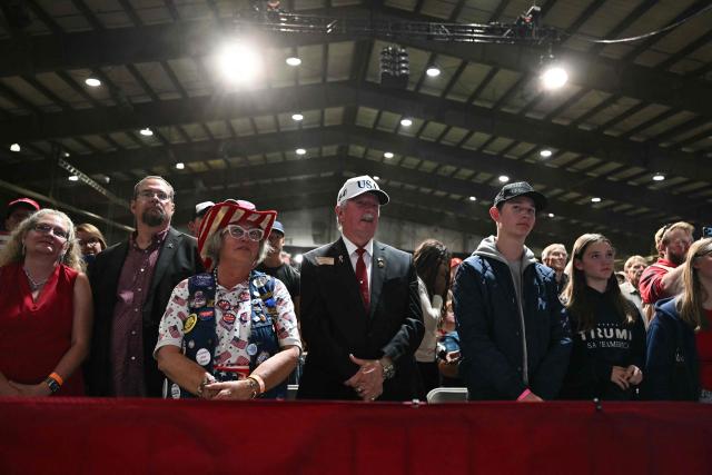 Supporters listen to US President Donald Trump speak during a campaign rally at the Majestic Valley Arena in Kalispell, Montana on October 14, 2026. President Trump is campaigning for US Congressional candidate Aaron Flint. (Photo by Kent NISHIMURA / AFP)