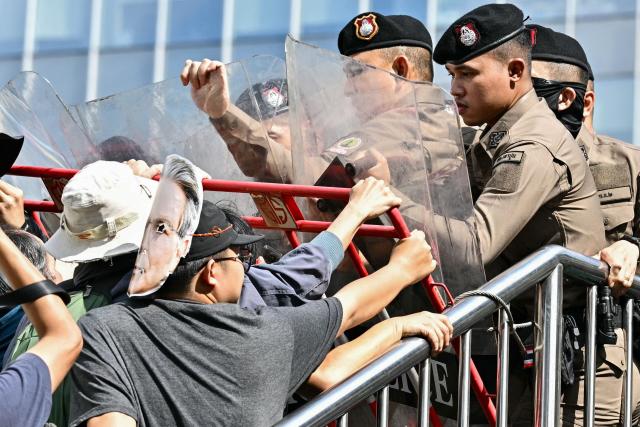 Police face off with demonstrators during a protest against the International Monetary Fund (IMF) and World Bank Group in Bangkok on October 15, 2026, as the IMF Annual Meetings take place in the Thai capital. (Photo by ANTHONY WALLACE / AFP)