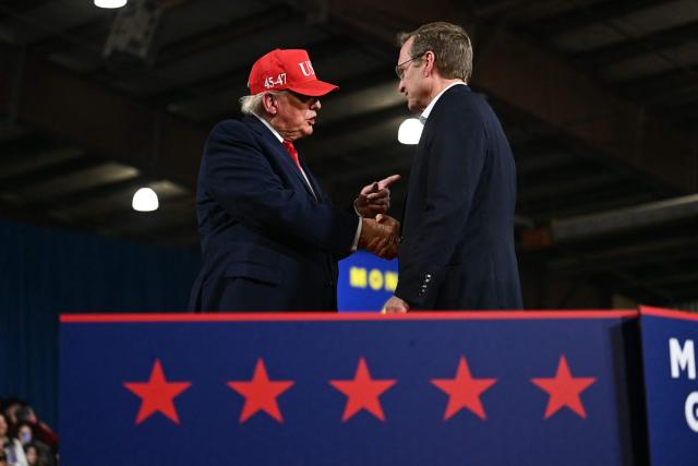 Republican candidate for US Senate Kurt Alme shakes hands with US President Donald Trump during a campaign rally at the Majestic Valley Arena in Kalispell, Montana on October 14, 2026. President Trump is campaigning for Aaron Flint and Alme. (Photo by Kent NISHIMURA / AFP)