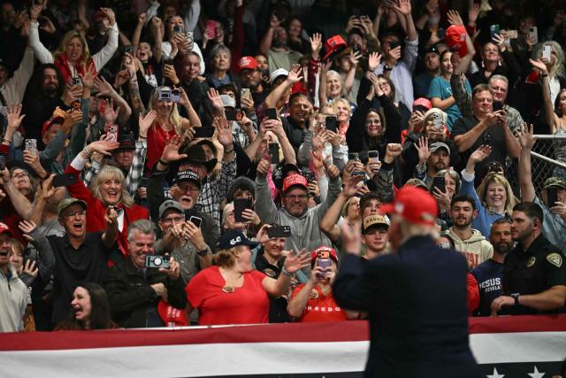 Supporters cheer US President Donald Trump as he walks off stage during a campaign rally at the Majestic Valley Arena in Kalispell, Montana on October 14, 2026. President Trump is campaigning for US Congressional candidate Aaron Flint. (Photo by Kent NISHIMURA / AFP)