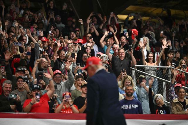 Supporters cheer US President Donald Trump as he walks off stage during a campaign rally at the Majestic Valley Arena in Kalispell, Montana on October 14, 2026. President Trump is campaigning for US Congressional candidate Aaron Flint. (Photo by Kent NISHIMURA / AFP)