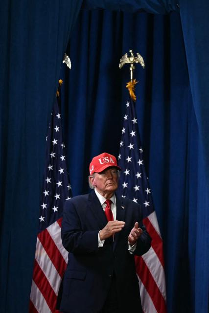 US President Donald Trump claps as he walks off stage during a campaign rally at the Majestic Valley Arena in Kalispell, Montana on October 14, 2026. President Trump is campaigning for US Congressional candidate Aaron Flint. (Photo by Kent NISHIMURA / AFP)