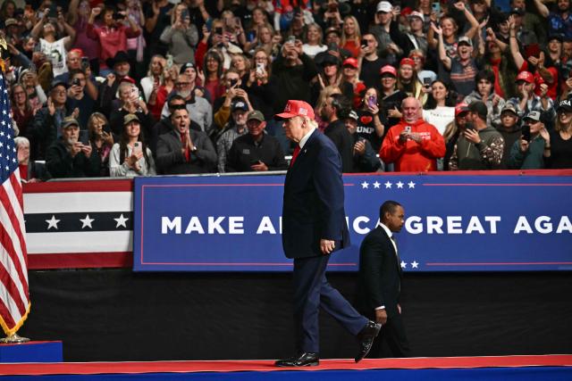 US President Donald Trump walks off stage after speaking at a campaign rally at the Majestic Valley Arena in Kalispell, Montana on October 14, 2026. President Trump is campaigning for US Congressional candidate Aaron Flint. (Photo by Kent NISHIMURA / AFP)