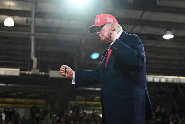 US President Donald Trump dances as he walks off stage at a campaign rally at the Majestic Valley Arena in Kalispell, Montana on October 14, 2026. President Trump is campaigning for US Congressional candidate Aaron Flint. (Photo by Kent NISHIMURA / AFP)