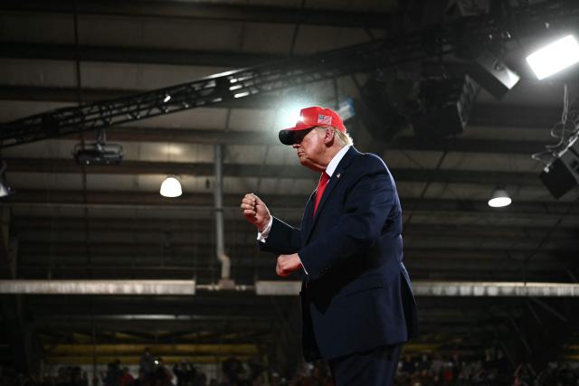 US President Donald Trump dances as he walks off stage at a campaign rally at the Majestic Valley Arena in Kalispell, Montana on October 14, 2026. President Trump is campaigning for US Congressional candidate Aaron Flint. (Photo by Kent NISHIMURA / AFP)