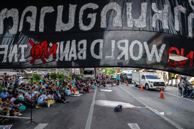 Demonstrators take part in a protest against the International Monetary Fund (IMF) and World Bank Group in Bangkok on October 15, 2026, as the IMF Annual Meetings take place in the Thai capital. (Photo by ANTHONY WALLACE / AFP)