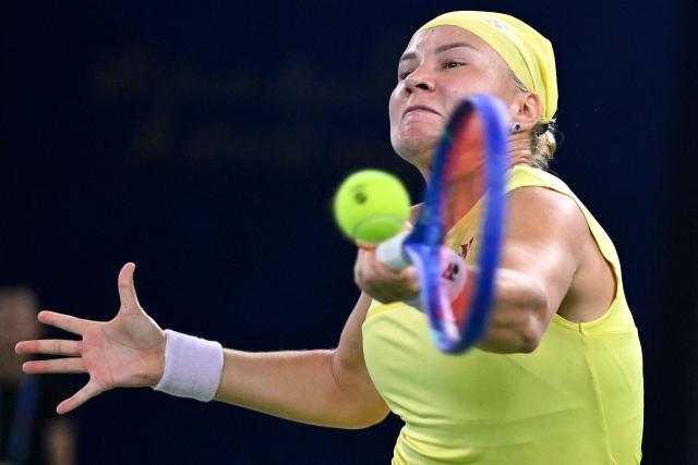 Russia's Diana Shnaider hits a return to Czech Republic's Karolina Muchova during their women's singles tennis match at the Wuhan Open tennis tournament in Wuhan, China's Hubei province on October 15, 2026. (Photo by WANG Zhao / AFP)