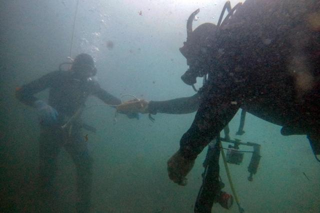 Oceanographer Diego Lopez and a fisherman diver measure an area in a macroalgae forest as part of a restoration project on the Baja California Peninsula, near Puerto Nuevo, Baja California state, Mexico, on October 1, 2026. Scientists and fishermen in Mexico are diving into the Pacific Ocean off Baja California to help restore giant kelp forests devastated by warming waters linked to El Nino, after a particularly severe 2015 event wiped out large areas of the underwater ecosystem. El Nino conditions expected this year and in 2027 threaten to further impact one of the region's most important marine habitats. (Photo by Guillermo Arias / AFP)