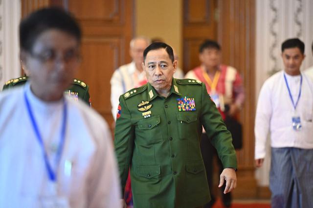 Myanmar's Defence Minister Yar Pyae (C) arrives to attend a ceremony marking the 11th anniversary of the signing of the Nationwide Ceasefire Agreement (NCA) in Naypyidaw on October 15, 2026, amid the ongoing civil war that has killed an estimated 100,000 people since 2021. Myanmar marked on October 15 the 11th anniversary of the Nationwide Ceasefire Agreement (NCA), which brokered peace with some of the countrys myriad armed factions in 2015. A number of groups pulled out of the landmark deal in the wake of the 2021 military coup which unleashed a full-blown civil war. The government presents the faltering agreement as a path to new peace talks, but many of the most powerful armed factions refuse to engage. (Photo by SAI AUNG MAIN / AFP)